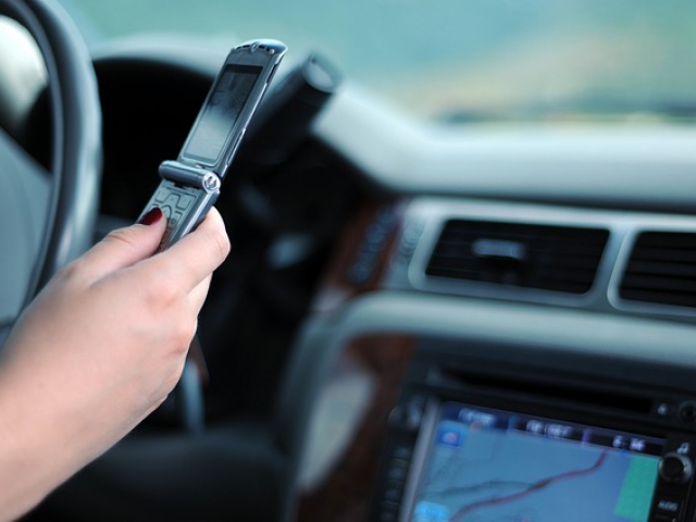 You receive a text message while you’re driving. What do you do next?